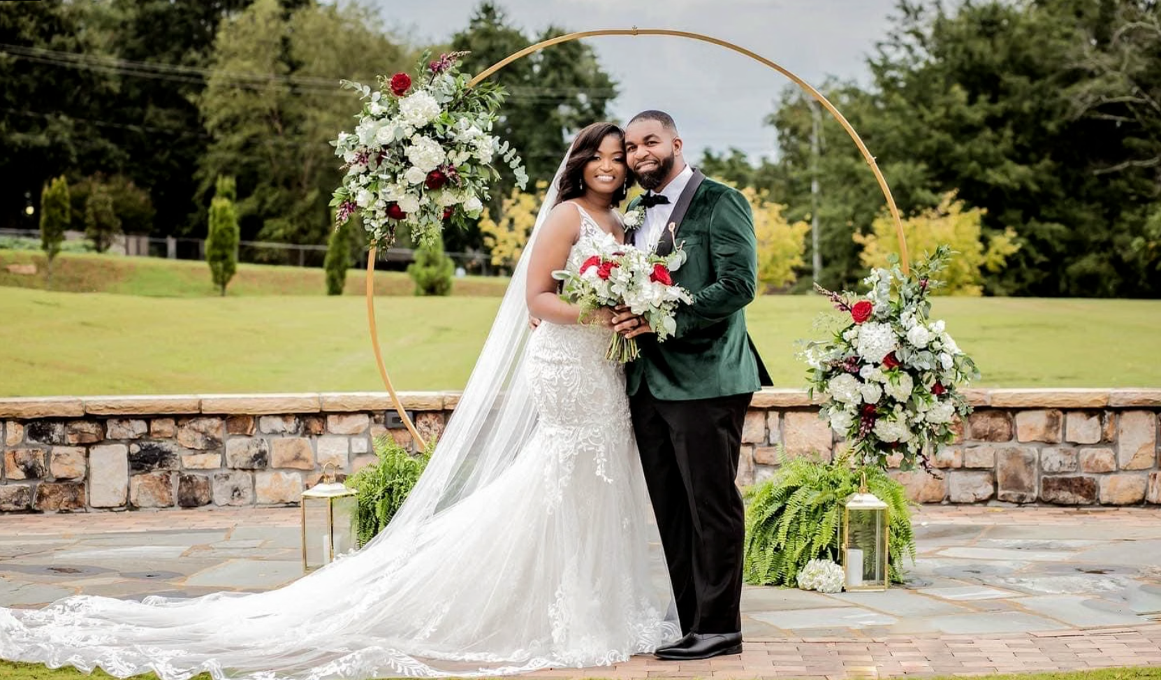 Newlyweds beneath a floral arch